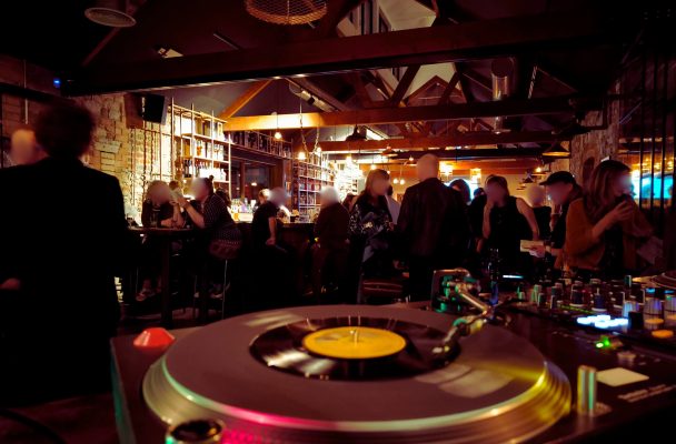 DJ spinning vinyls in the DLD bar